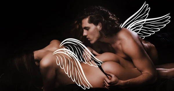 Angels couple, valentines day photo banner. Sexy couple play in love games. Sensual woman in erotic lingerie lie under muscular man. Sexy elegant couple in the tender passion