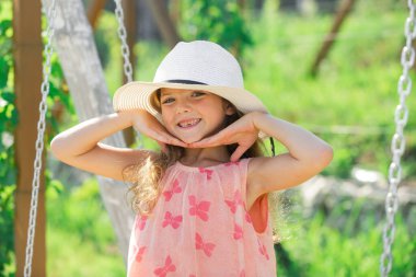 Adorable little girl portrait closeup outdoors in summer. Summer vacation and happy childhood. Emotional portrait of a cheerful and positive smiling teen girl