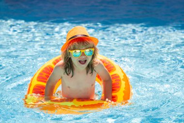 Çocuk havuzda oynuyor. Yaz tatili kavramı. Yaz çocukları sahilde deniz suyunda portre yapar.