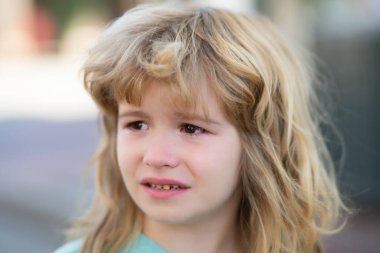 Portrait of a crying child with tears, close-up. The kid is crying