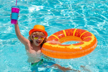 Kids swim swimming pool. Summer vacation concept. Summer kids portrait in sea water on beach. Blue water poolside. Summer kids cocktail
