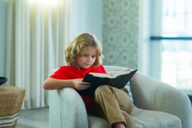 Kid read book at home. Concept of education, childhood, book reading and inspiration