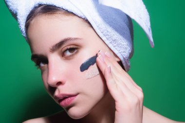 Beautiful woman applying moisturizer cream her face. Beauty concept. Skincare and pampering. Anti aging cream. Young model applyed cream. Girl applying cosmetic cream treatment on face