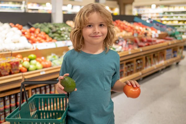 Little child choosing food in grocery store or a supermarket