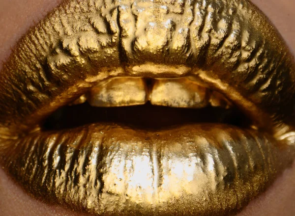 Lip icon with golden glitter effect. Sensual mouth. Symbol of kiss from golden lipstick. Glamour luxury gold mouth. Golden effect on the lips