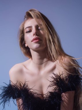 Beauty face of young blonde woman. Sexy model posing in studio. Portrait of beautiful girl. Beauty woman face closeup. Pretty girl face on studio background. Sensual look. Beautiful female face