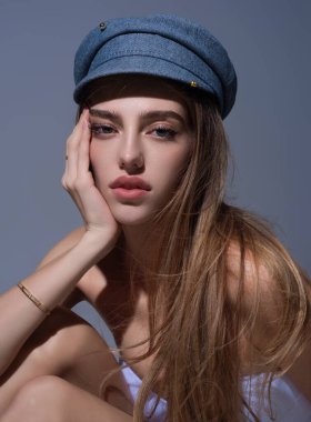Sexy attractive woman posing with cap. Beautiful sexy model portrait. Beauty woman face. Attractive sensual girl with fashion hat, close up