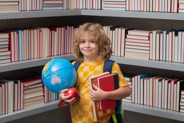 School boy world globe and books. Back to school. Funny little boy from elementary school with book. Education