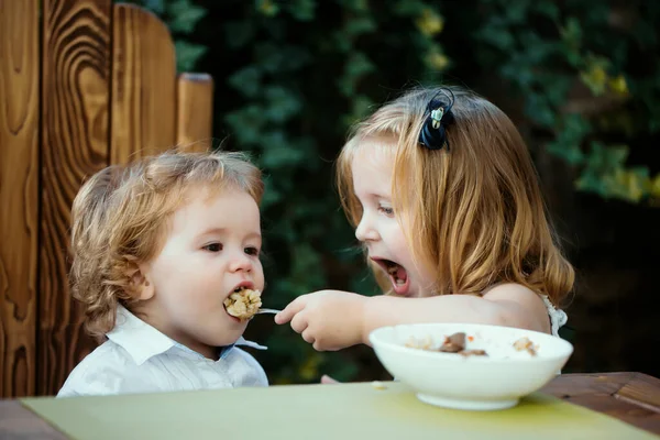 Sister Feeding Baby Boy Girl Feeds Brother Spoon Kid Food — Stock Photo, Image