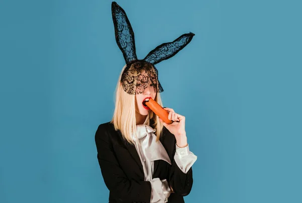Bunny woman with carrot. Easter rabbit girl with black ears