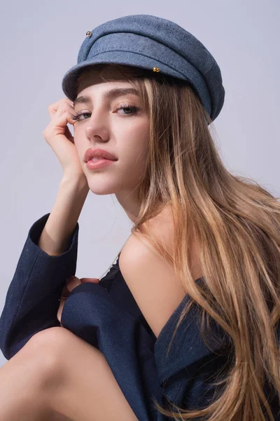 Sexy attractive woman posing with cap. Beautiful sexy model portrait. Beauty woman face. Attractive sensual girl with fashion hat, close up