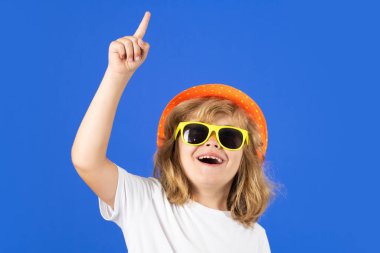 Funny summer fashion kid boy. Excited kid boy on studio isolated background. Surprised face, amazed emotions of child