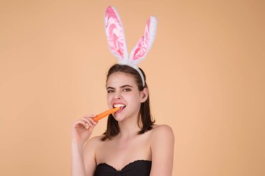 Easter bunny girl wear easter fluffy bunny ears hold easter eggs, isolated studio background. Eater portrait of female bunny