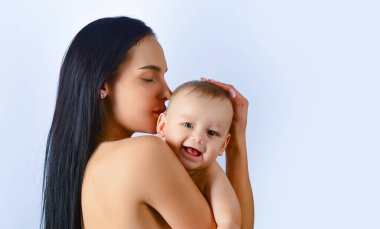 Mother hug. Closeup studio portrait of mother and baby child isolated on whtite. Mother hugging and embracing baby son. Mothers day, love family. Mother and baby child with tenderness