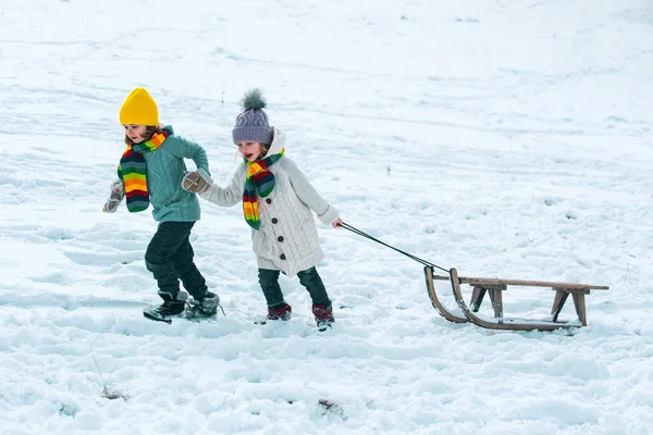 そり付きの冬の子供 積極的な冬の屋外ゲーム クリスマス休暇のコンセプト — ストック写真