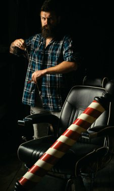 Hair salon and barber vintage. Brutal guy in modern Barber Shop. Trims. Great time at barbershop. Barber making haircut of attractive bearded man in barber shop. Bearded man or hipster