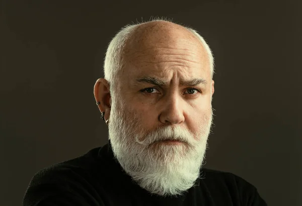 Portrait of a mature man on black background