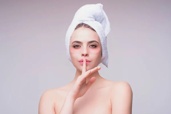 Woman applying eye patches. Close up portrait of girl with collagen pad patches under eyes, taking care of delicate skin around eyes. Woman patches rejuvenation skin care
