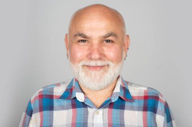 Portrait of happy senior man smiling. Face of 50s aged pensioner. Portrait of senior man in studio. Grey hair senior model. Old male portrait
