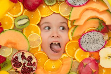 Healthy vitamins fruits. Kids face with mix of fresh frutis. Healthy nutrition food for kids