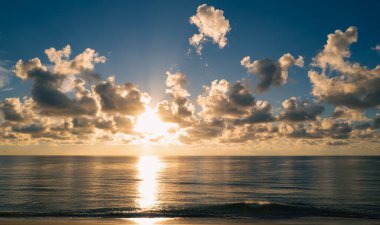 Sunset in the sea with beautiful clouds. Sunrise sea on tropical beach. Landscape of beautiful beach. Beautiful sunset at sea. Caribbean sea. Ocean sunset on sky background with colorful clouds
