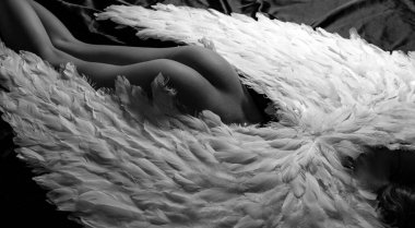 Fallen white angel. Romantic young beauty ass an angel. Long white wings. Sexy Valentines Day concept. Erotic buttocks. Beautiful sensual woman nude posing with angel wings