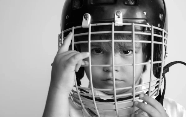 Hockey or rugby helmet. Sport childhood. Future sport star. Sport upbringing and career. Boy cute child wear hockey helmet close up. Safety and protection. Protective grid on face. Sport equipment.