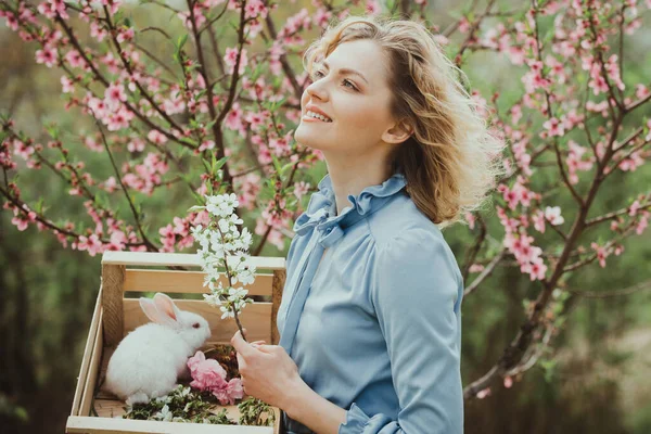 stock image Spring day. Woman planting flowers. Beautiful woman on Background with flowers on a spring day