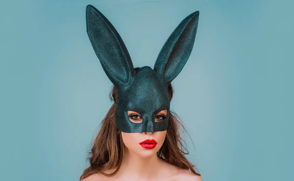 Easter bunny woman in black lace mask. Egg hunt. Rabbit ears