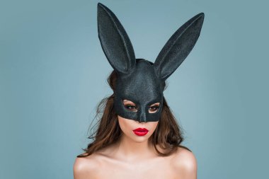 Lovely, romantic sexy woman in rabbit ears celebrating easter holiday, studio background. Holidays, spring and party concept. Sensual girl celebrating Easter in rabbit ears
