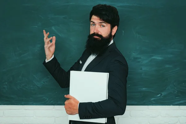 Professor in class on blackboard background. Chalkboard copy space. Teachers day