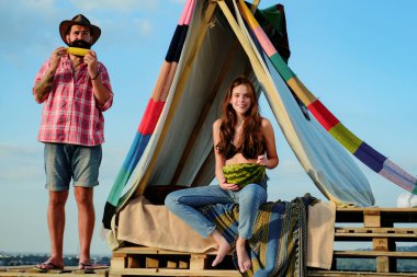 Romantic couple camping on spring landscape. Adventure for young lovers campers in tent on nature. Breakfast with lovers on camp