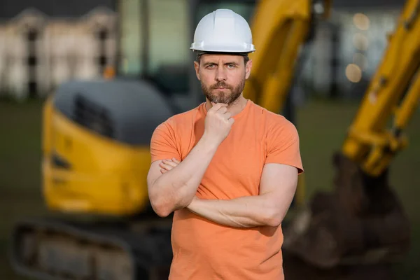 Portrait of worker small business owner. Construction worker with hardhat helmet on construction site. Construction engineer worker in builder uniform with excavation digging. Worker construction