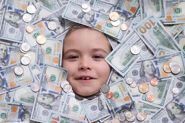 Winner money. Funny child with fun face with money. Kid peeking out of dollar bills with astonished shocked eyes. Money background
