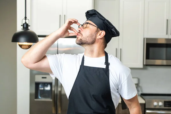 Man chef cooker, baker. Male chefs with sign of perfect food. Chef cooking, showing sign for delicious. Chef, cook making tasty delicious gesture by kissing fingers. Chefs cook in hat and apron kiss