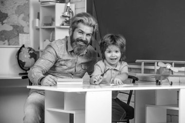 İlkokul öğretmeni. Öğretmen ve öğrenci sınıfa. İlkokul öğrencisi içeride okuyor. Özel ders ajansı. Ev çalışması