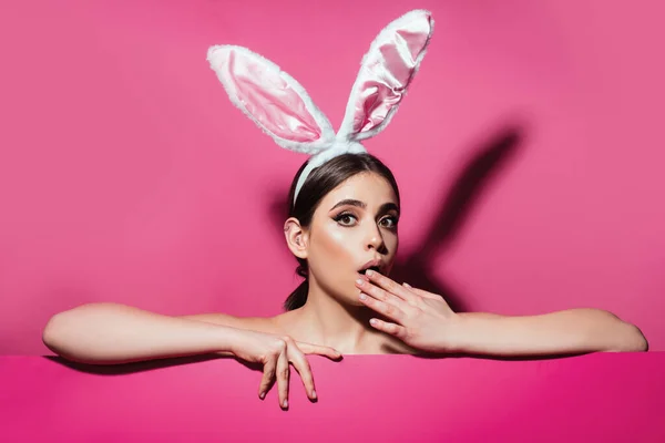 Young Woman Wearing Bunny Ears Peeking Surface Isolated Pink — Stock Photo, Image