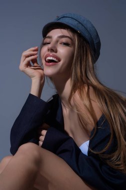 Sensual close up portrait of elegant young fashionable sexy woman in fashion cap hat. Beautiful girl, fashion model. Fashion lady. Stylish woman in fashion trend look. Sexy clothes