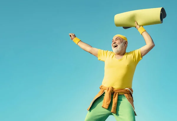 Portrait of healthy senior sport man. Cheerful aged men holding yoga mats. Exercising. Energetic for elderly sportsmen