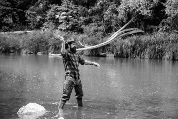 stock image Elegant bearded brutal hipster man fishing. Fish on hook. Catch me if you can. Nice day for fishing. Keep calm and fish on. Fisherman with fishing rod. Handsome fisherman