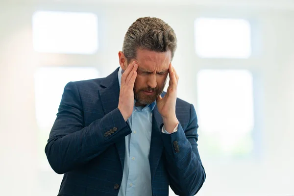 Tired, headache and eye strain. Businessman with stress, burnout and fatigue eyestrain. Mature middle aged senior man rubbing tired eyes. Vision problem, bad sight, feeling eyestrain fatigue pain