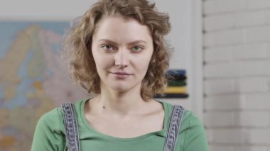 Young teacher, close up portrait. Funny female young teacher in the classroom. College or university people