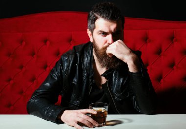 Hangover depressed man after hard drinking. Bad alcohol habits. Alcohol abuse. Depressed man drinking whisky at restaurant clipart