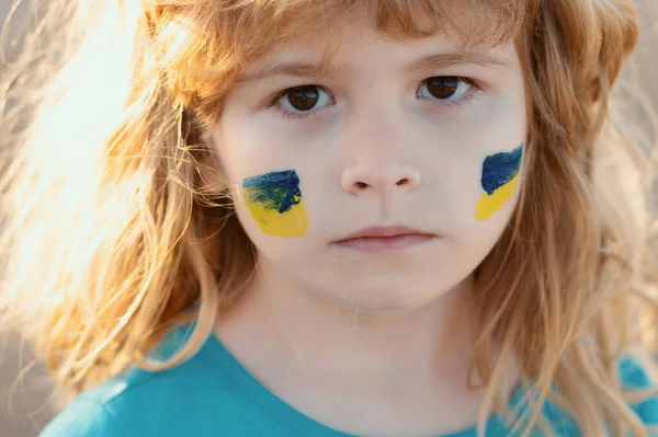 stock image Ukraine flag on kids cheek. Little ukrainian patriot