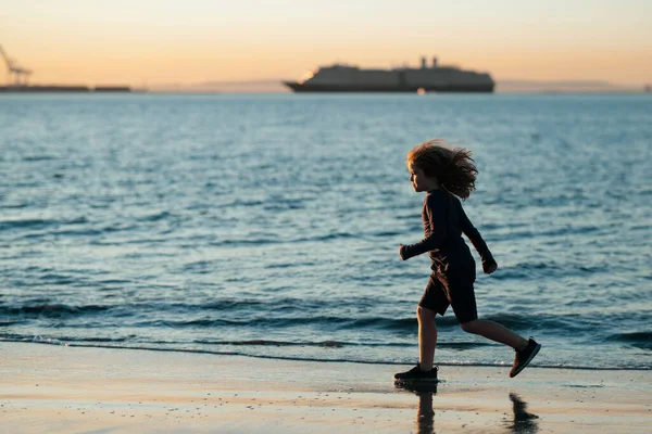 子供はビーチで走ってる 幸せな子供は夏休みに海で走ります 子供と夏休み — ストック写真
