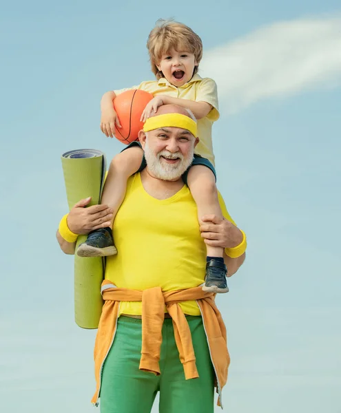 stock image Elderly sporty man and young boy sporting morning workout - copy space. Healthy family lifestyle. Sport yoga and fitness. Rehabilitation