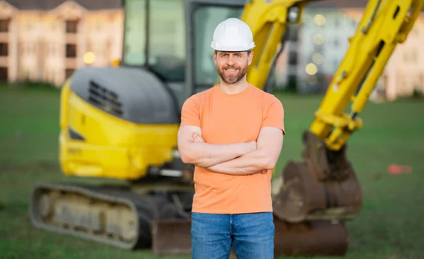 Builder at building site. Construction manager in helmet. Male construction engineer. Architect at a construction site. Handyman builder in hardhat. Building concept. Builder foreman