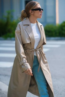 Trendy coat. High fashion model walking on city street. Girl fashion style. Fashion beautiful elegant woman. Young woman wearing fashionable clothes. Girl vogue style. Fashion shot