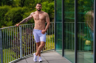 Portrait of handsome sporty man with muscular body doing weight lifting. Guy workout at gym. Fitness trainer, sport instructor, sporty man, fit model, sportsman workout. Power athletic guy bodybuilder