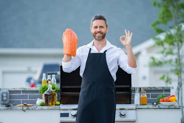 Barbecue Master Chef Apron Hold Salmon Fillet Bbq Middle Aged — Stock Photo, Image